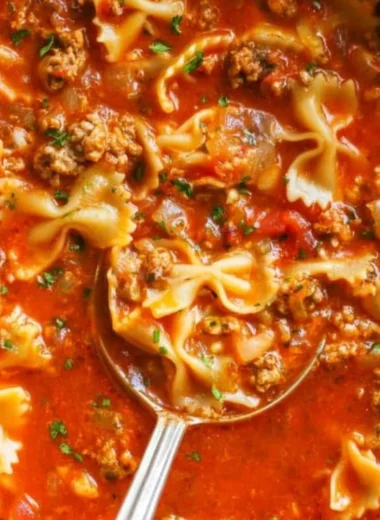 Delicious one-pot lasagna soup in a bowl, garnished with cheese and herbs