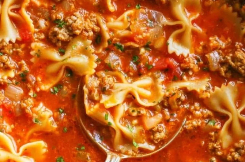 Delicious one-pot lasagna soup in a bowl, garnished with cheese and herbs