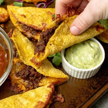 Delicious crispy beef tacos served with fresh toppings and garnishes.